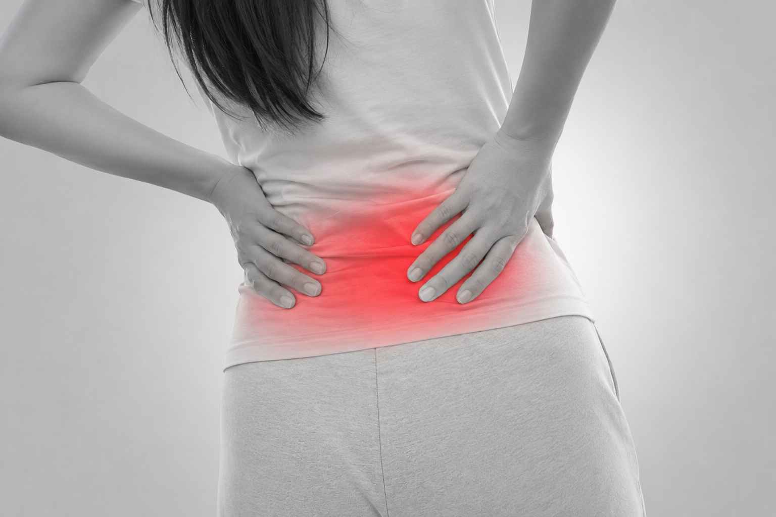 痛みで腰を押さえる女性